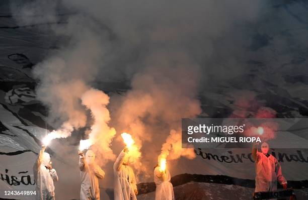Vitoria Guimaraes' supporters light flares before the start of the Portuguese League football match between Vitoria Guimaraes SC and SL Benfica at...