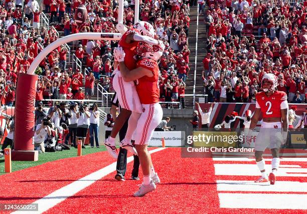 Jaylen Dixon of the Utah Utes jumps into the arms of teammate Dalton Kincaid after scoring a touchdown against the Oregon State Beavers during the...