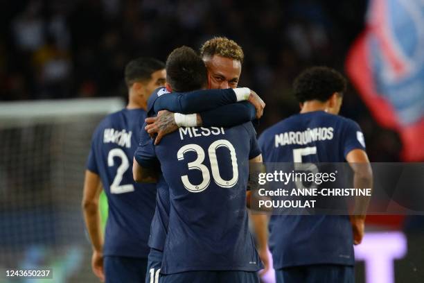 Paris Saint-Germain's Argentine forward Lionel Messi is congratulated by Paris Saint-Germain's Brazilian forward Neymar after scoring a goal during...