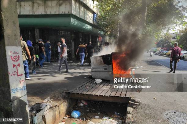 Iranian protesters set fire to property while marching down a street on October 1, 2022 in Tehran, Iran. Protests over the death of 22-year-old...