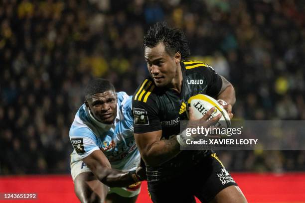 La Rochelle's Ulupano Seuteni runs with the ball on his way to scoring a try during the French Top 14 rugby union match between La Rochelle and...
