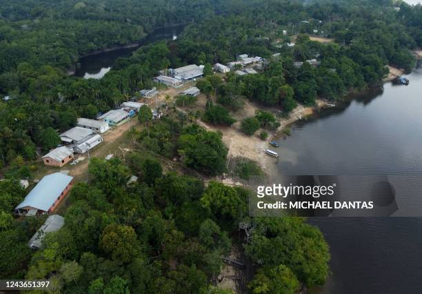 Aerial view showing Electoral Justice employees delivering electronic ballots to remote riverside communities alongside the Negro river, on the eve...