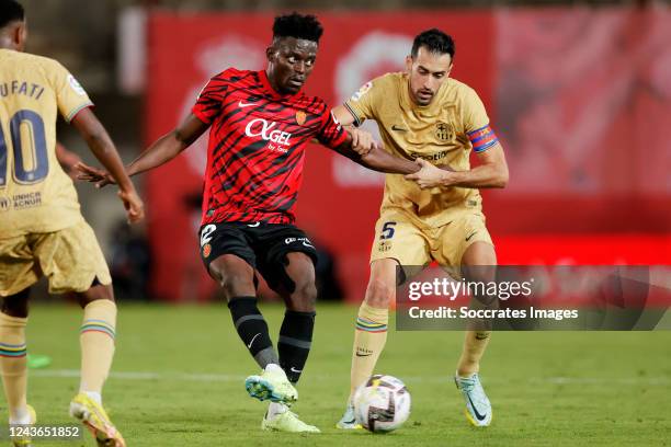 Iddrisu Baba of Real Mallorca Sergio Busquets of FC Barcelona during the La Liga Santander match between Real Mallorca v FC Barcelona at the Visit...