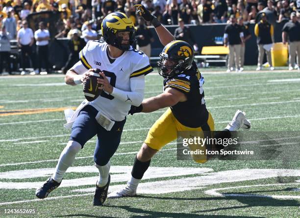 Iowa left defensive tackle Lukas Van Ness reaches in to tackle Michigan quarterback J.J. McCarthy during a college football game between the Michigan...