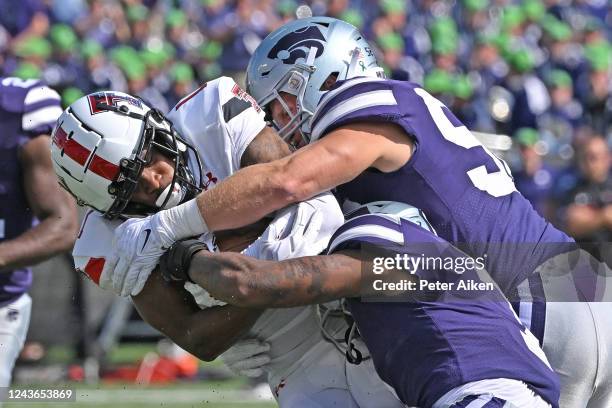 Linebacker Nick Allen of the Kansas State Wildcats and safety Nick Allen tackle wide receiver Myles Price of the Texas Tech Red Raiders during the...