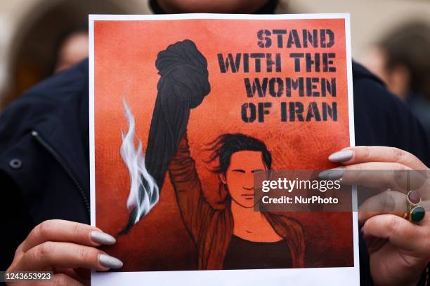 Banner 'Stand with the women of Iran' is seen during solidarity demonstration in memory of Mahsa Amini, at the Main Square in Krakow, Poland on...