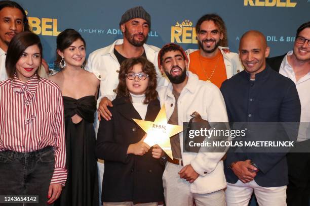 Belgian directors Bilall Fallah and Adil El Arbi pose with cast members at the premiere of the film 'Rebel', at the Kinepolis cinema in Brussels on...