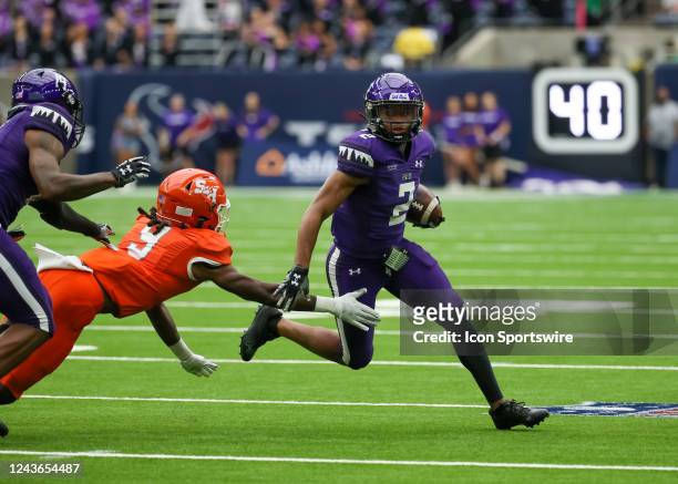 Stephen F. Austin Lumberjacks wide receiver Xavier Gipson avoids a tackle by Sam Houston State Bearkats wide receiver Cody Chrest during the Battle...