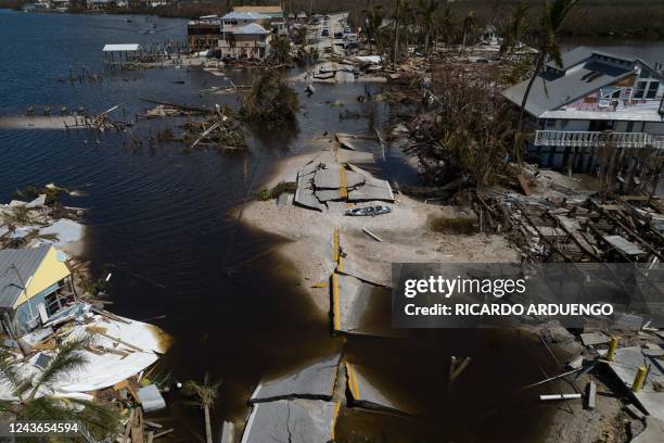 An aerial picture taken on October 1, 2022 shows a broken section of the Pine Island Road, debris and destroyed houses in the aftermath of Hurricane...