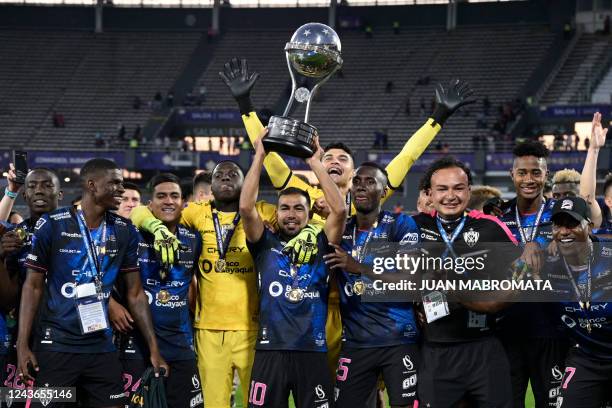 Independiente del Valle players celebrate with the trophy of the Copa Sudamericana football tournament after the final match between Sao Paulo and...