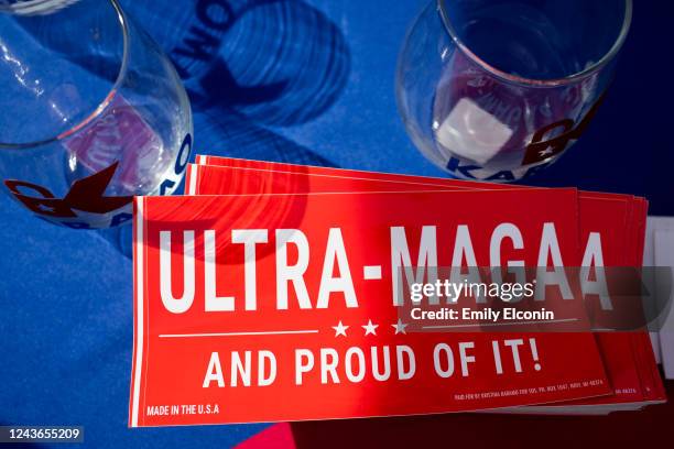 Stickers on display at different booths as people wait in line to see Former President Donald Trump at a Save America rally on October 1, 2022 in...