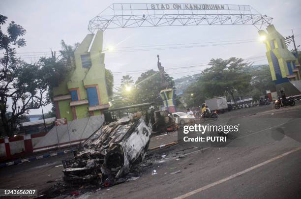 This picture shows a torched car outside Kanjuruhan stadium in Malang, East Java on October 2, 2022. - At least 127 people were killed when angry...