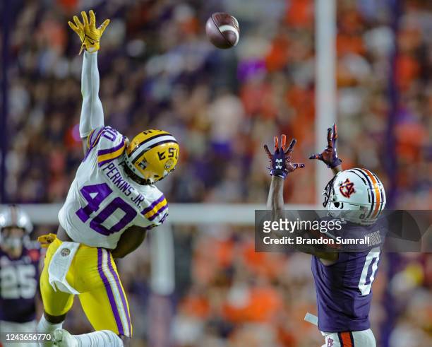Koy Moore of the Auburn Tigers hauls in a pass beyond the reach of Harold Perkins Jr. #40 of the LSU Tigers at Jordan-Hare Stadium on October 1, 2022...