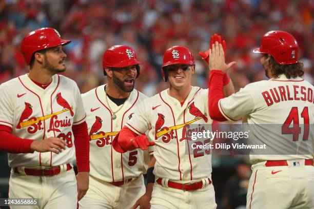 Nolan Arenado, Albert Pujols and Corey Dickerson all of the St. Louis Cardinals celebrate after Dickerson hit a grand slam against the Pittsburgh...