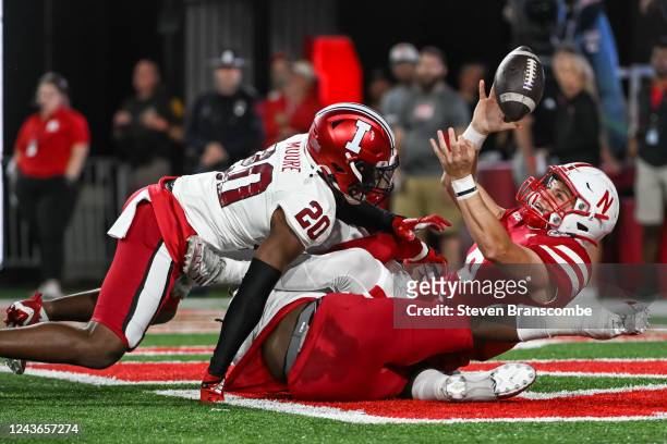 Quarterback Chubba Purdy of the Nebraska Cornhuskers fumbles in the endzone against defensive back Louis Moore of the Indiana Hoosiers leading to a...