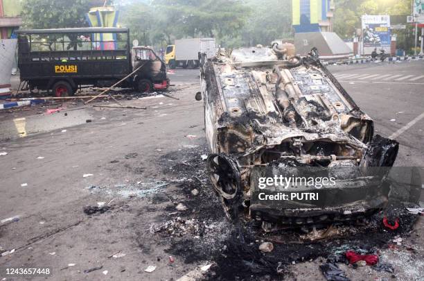 This picture shows torched vehicles outside Kanjuruhan stadium in Malang, East Java on October 2, 2022. - At least 127 people were killed when angry...