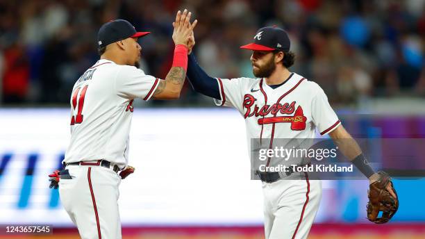 Dansby Swanson and Orlando Arcia of the Atlanta Braves celebrate the 4-2 victory over the New York Mets at Truist Park on October 1, 2022 in Atlanta,...