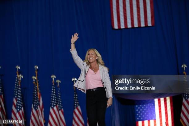 Rep. Majorie Taylor Greene waves to the crowd before she makes speaks during a Save America rally on October 1, 2022 in Warren, Michigan. Trump has...