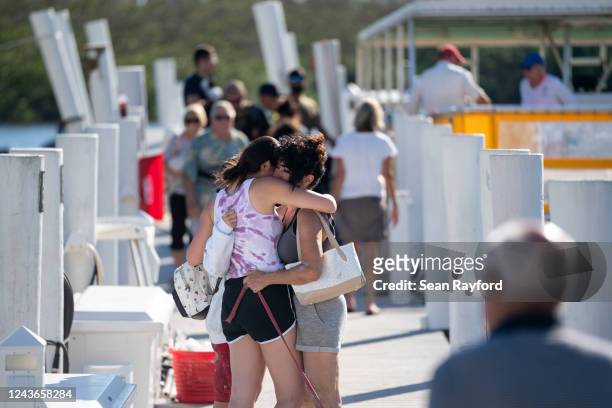 Isabella Sbarro, left, hugs her mother, Amy Sbarro, after Amy was evacuated by boat from the isolated Sanibel Island in the wake of Hurricane Ian on...