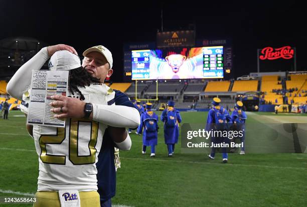 Head Coach Brent Key of the Georgia Tech Yellow Jackets hugs LaMiles Brooks after a 26-21 win over the Pittsburgh Panthers at Acrisure Stadium on...