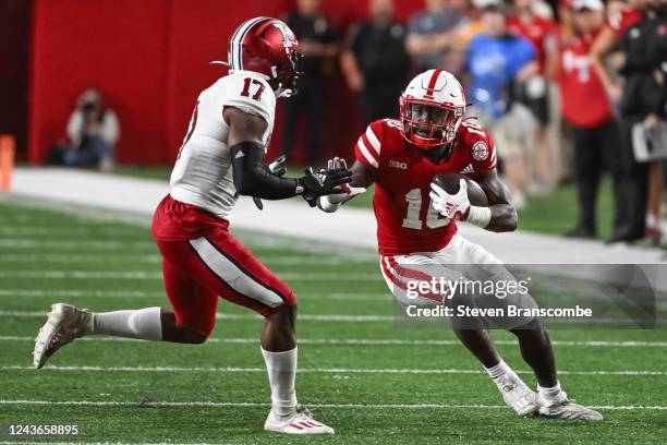 Anthony Grant of the Nebraska Cornhuskers runs from Jonathan Haynes of the Indiana Hoosiers in the fourth quarter of the game at Memorial Stadium on...