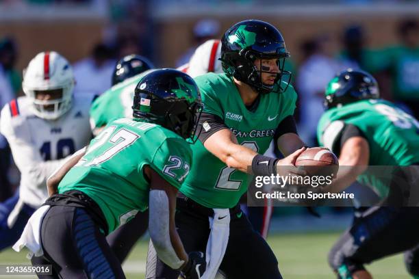 North Texas Mean Green quarterback Austin Aune hands-off the football to running back Oscar Adaway III during the game between the North Texas Mean...
