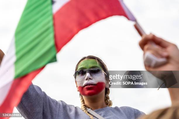Woman with her face painted with Iranian flag colours seen during a demonstration in solidarity with Iranian women, as part of planned worldwide...