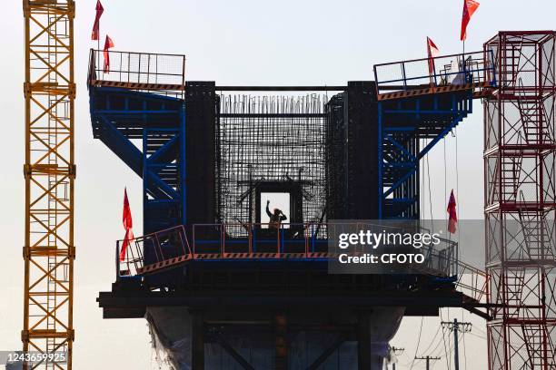 Builders work at the pier construction site of the Baotou-Yinchuan high-speed railway bridge across Kundulun River in Baotou city, Inner Mongolia...