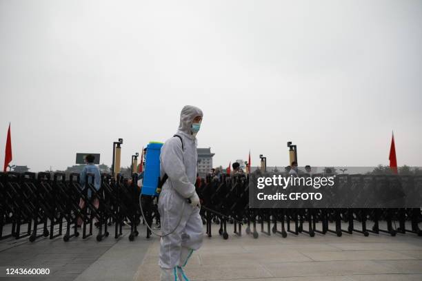 Staff member performs disinfection inside the Ming City Wall scenic area in Xi 'an, Shaanxi province, China, Oct 1, 2022.