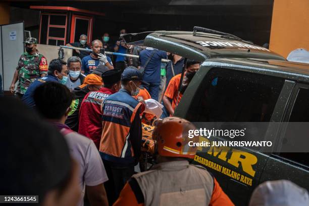 Medical workers receive a body at a hospital in Malang, East Java on October 2, 2022. - At least 174 people died at an Indonesian football stadium...