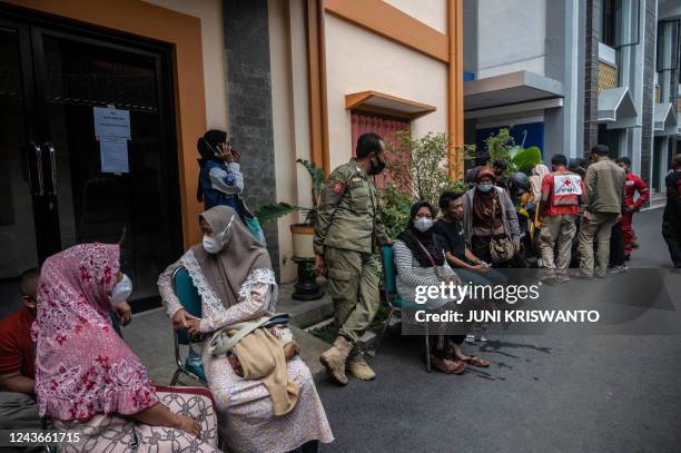 Relatives of victims wait outside a hospital in Malang, East Java on October 2, 2022. - At least 174 people died at an Indonesian football stadium...