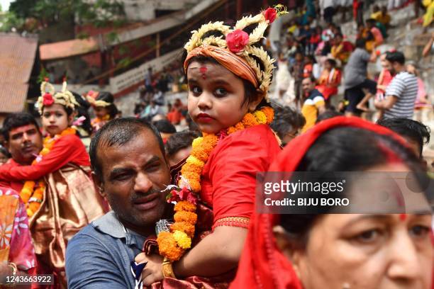 Devotees carry girls dressed as Hindu goddess Durga for the 'Kumari' rituals during the Durga Puja festival at Kamakhya Temple in Guwahati on October...