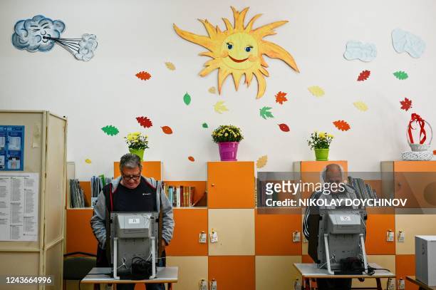Voters cast his ballot at a polling station during the country's parliamentary elections in Sofia on October 2, 2022. - Bulgarians began voting in...