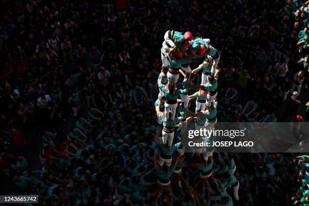 Members of the "Castellers de Vilafranca" human tower team form a "castell" during the 28th edition of the 'castells' competetion at the Tarraco...
