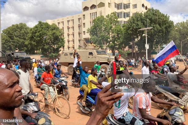 Burkina Faso Army armored vehicle is seen as protesters march carrying Russian flags in Ouagadougou on October 2, 2022. - Security forces fired tear...