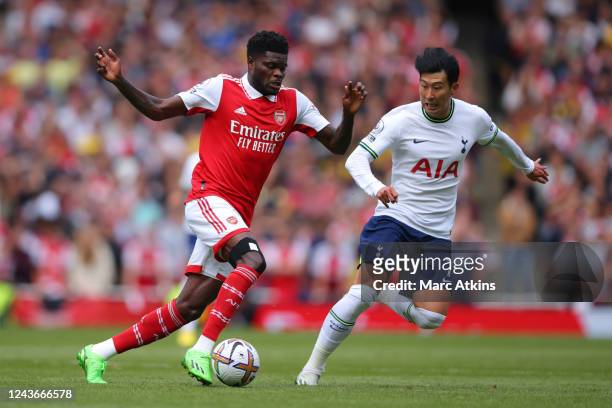 Thomas Partey of Arsenal in action with Son Heung-min of Tottenham Hotspur during the Premier League match between Arsenal FC and Tottenham Hotspur...