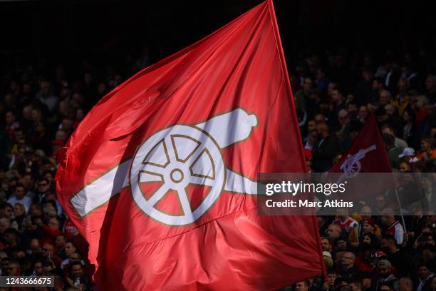 Arsenal fans display a flag featuring a Cannon during the Premier League match between Arsenal FC and Tottenham Hotspur at Emirates Stadium on...