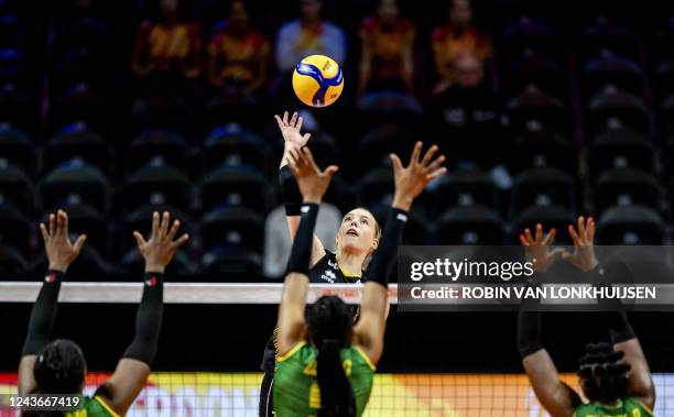 Belgium's Celine van Gestel of jumps for the ball against Cameroon's Estelle Adiana, Arielle Olomo Paule and Berthrade Simone Flore Bikatal during...