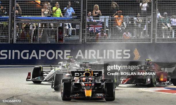 Red Bull Racing's Mexican driver Sergio Perez leads at the start of the Formula One Singapore Grand Prix night race at the Marina Bay Street Circuit...