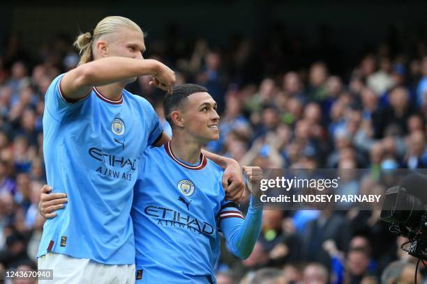 Manchester City's English midfielder Phil Foden celebrates scoring his team's sixth goal and his third with Manchester City's Norwegian striker...