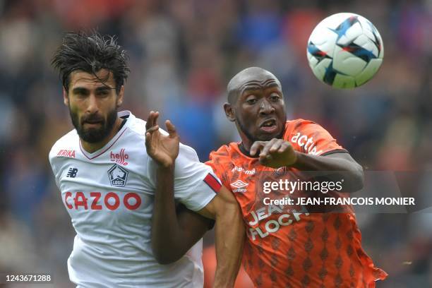 Lorient's Malian forward Ibrahima Kone fights for the ball with Lille's Portuguese midfielder Andre Gomes during the French L1 football match between...