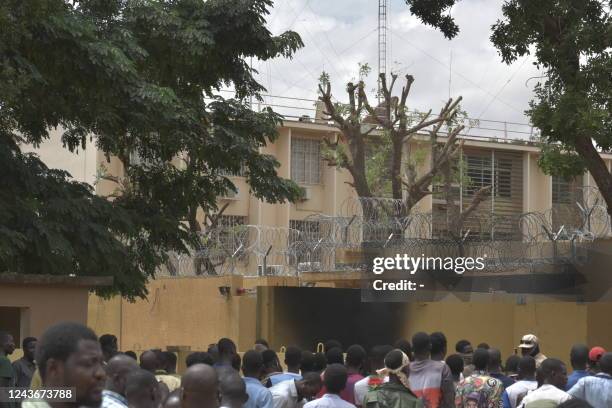 Crowd of protesters gather in front of the entrance to the French Embassy in Ouagadougou on October 2, 2022. Security forces fired tear gas to...