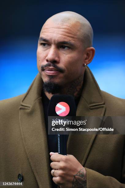 Former Manchester City player Nigel de Jong holds the microphone as he works as a pitchside pundit for Viaplay during the Premier League match...