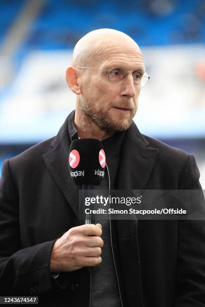 Former Manchester United defender Jaap Stam holds the microphone as he works as a pitchside pundit for Viaplay during the Premier League match...