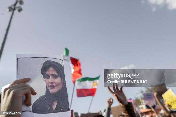 Protestors holds a photo of Kurdish Iranian woman Mahsa Amini during a demonstration against the Iranian regime and in support of Iranian women,...