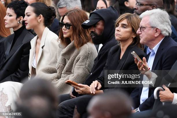 Rapper Kanye West , US singer Halsey and French fashion editor Carine Roitfeld attend the Givenchy Spring-Summer 2023 fashion show during the Paris...