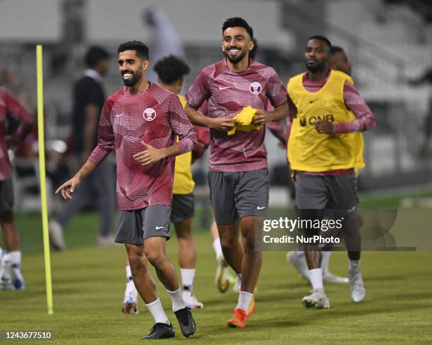 Hassan Al-Haydos and Tarek Salman of Qatar run during the Qatar national team open training session at the Jassim Bin Hamad Stadium, Doha, Qatar on...