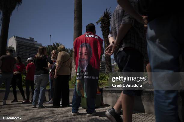 Brazilians residing in Argentina line up at the Brazilian Embassy to vote in the Brazilian presidential elections in Buenos Aires, Argentina, Oct....