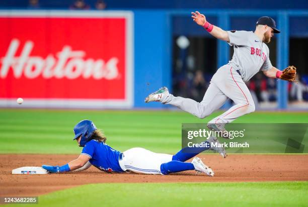 Bo Bichette of the Toronto Blue Jays steals a base under Christian Arroyo of the Boston Red Sox in the seventh inning during their MLB game at the...