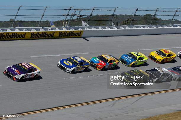 Denny Hamlin leads the field of cars through the 4th turn during the running of the Yellawood 500 NASCAR Cup Series Playoff race on October 2, 2022...
